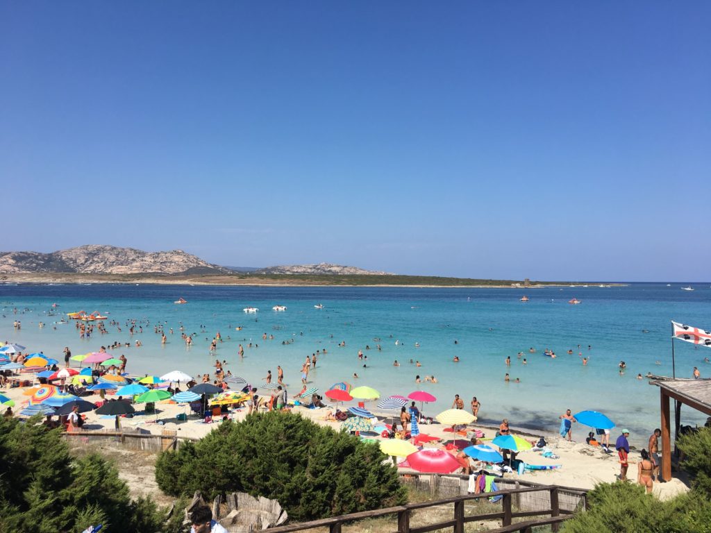 Shallow waters of La Pelosa beach, a must visit place in Sardinia with kids